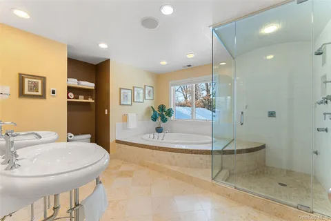 a spacious bathroom with a granite countertop sink a mirror and shower