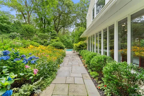 a view of a pathway with flower plants