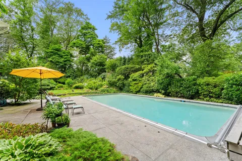 a view of a backyard with a swimming pool