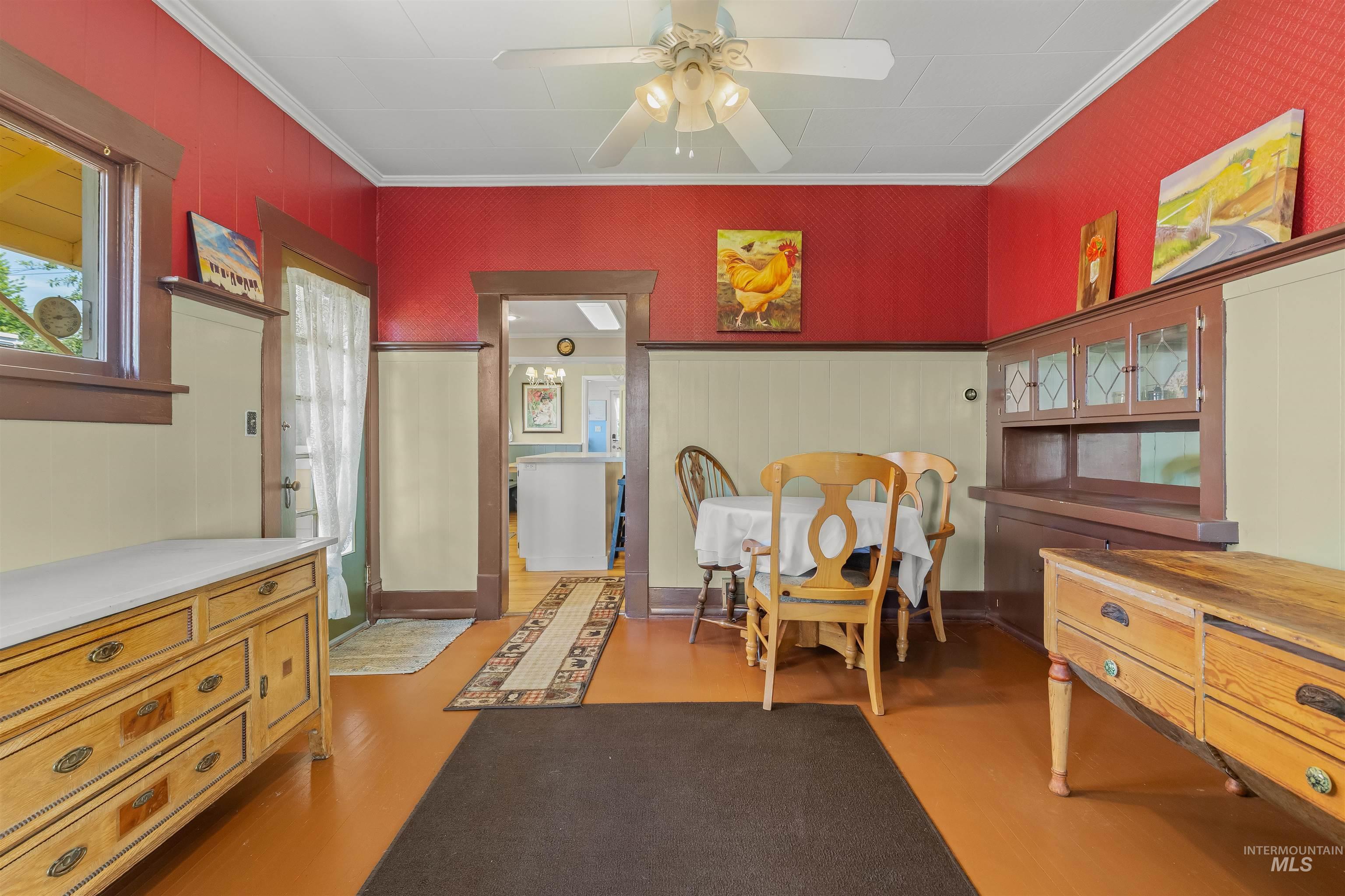 619 Prospect Avenue Lewiston, ID 83501 - Photo 11 of 37 Dining area featuring wood-finish flooring, a built-in china cabinet with leaded glass accents, and deep-toned wood trim