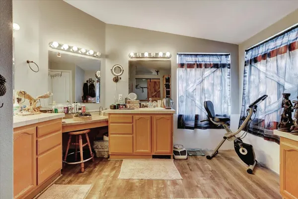 a bedroom with a bed a flat screen tv and a couch