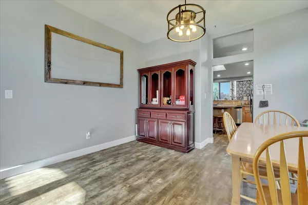 a living room with furniture potted plant and a chandelier