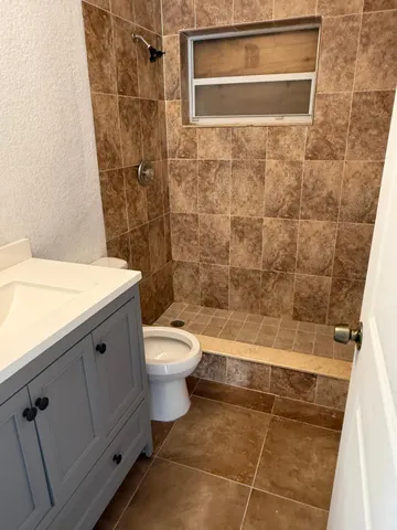 a bathroom with a toilet a sink and shower