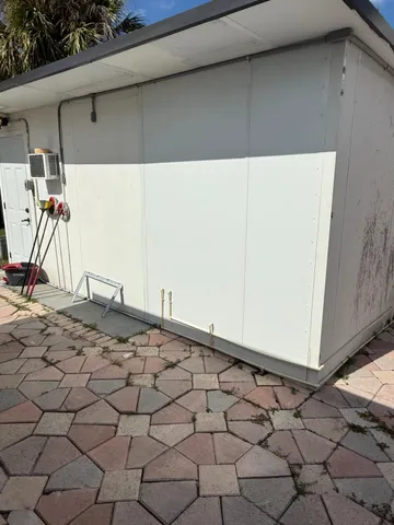 a view of a backyard space with a barbeque