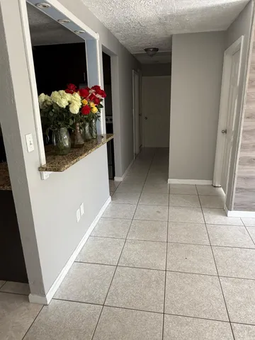 a view of an empty room and a window