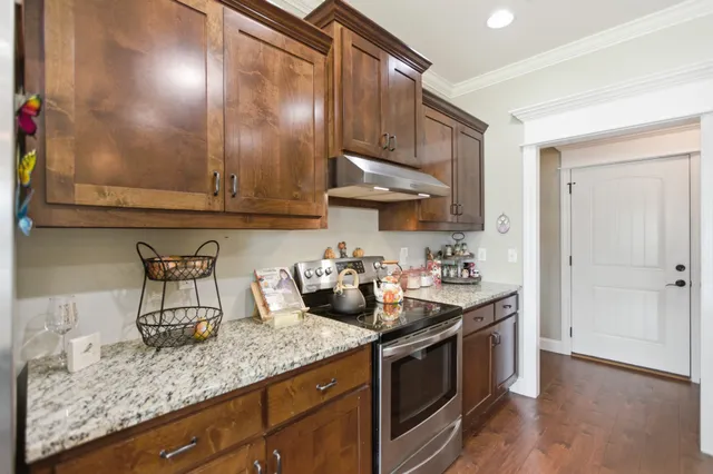 a kitchen with sink cabinets and stove top oven