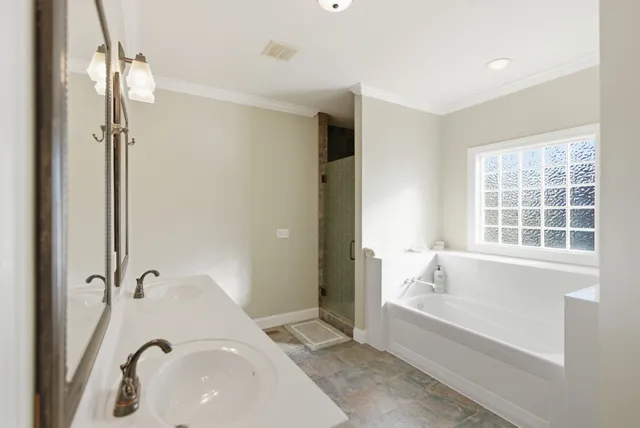 a bathroom with a bathtub and a shower