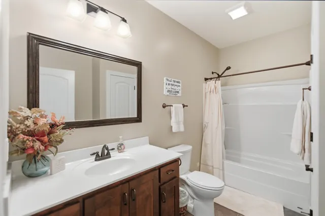a bathroom with a sink vanity and a mirror