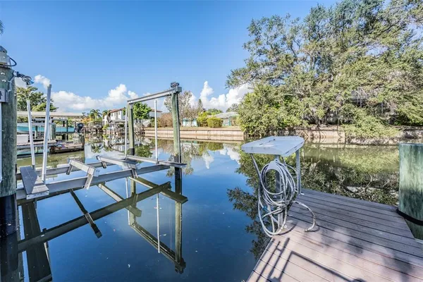 a view of a chairs and table in patio with a lake view