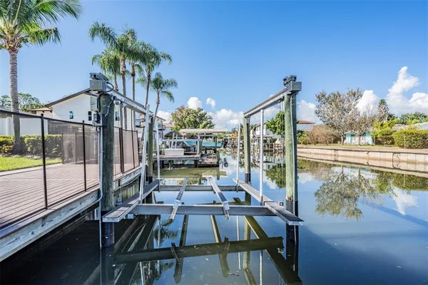 a balcony with chairs and with potted plants