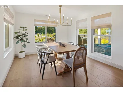 a dining room with furniture and wooden floor