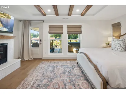 a spacious bedroom with a large bed and a chandelier