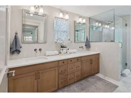 a bathroom with double vanity sink and a mirror