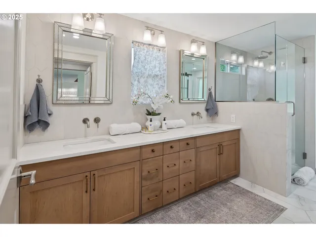 a bathroom with double vanity sink and a mirror