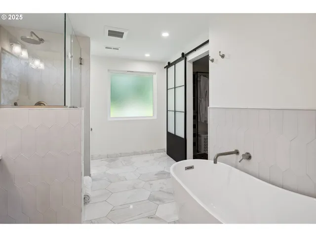 a bathroom with a bathtub and a shower
