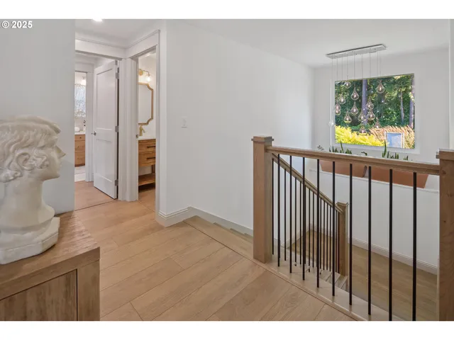 a view of hallway with wooden floor