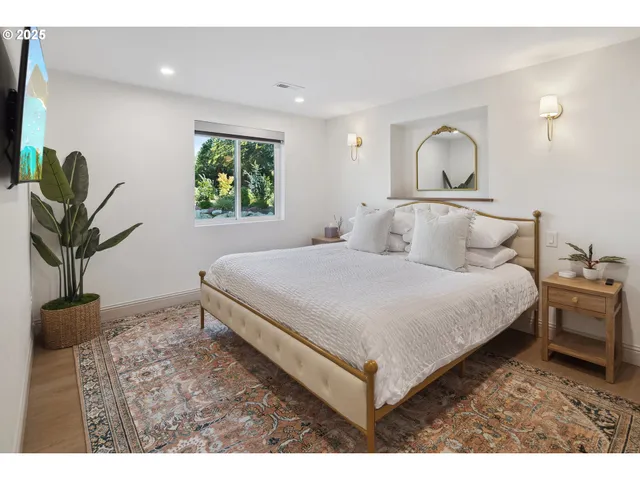 a bedroom with a bed and a potted plant