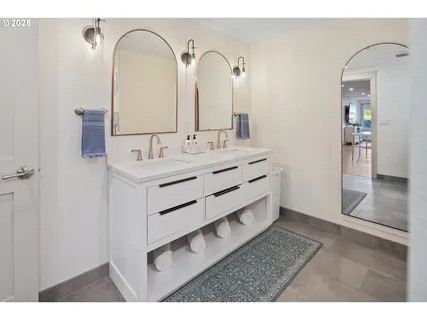 a bathroom with a double vanity sink and a mirror