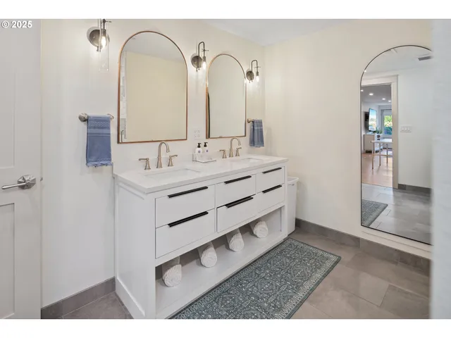 a bathroom with a double vanity sink and a mirror