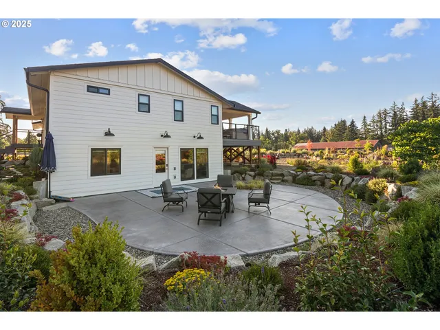 a backyard of a house with table and chairs