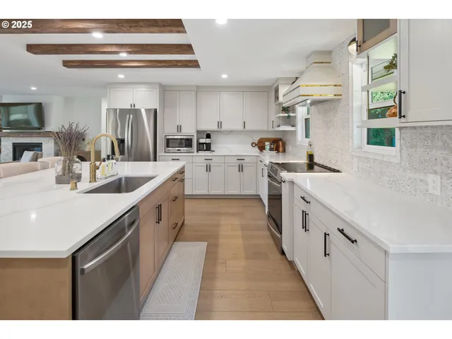a kitchen with white cabinets appliances and cabinets