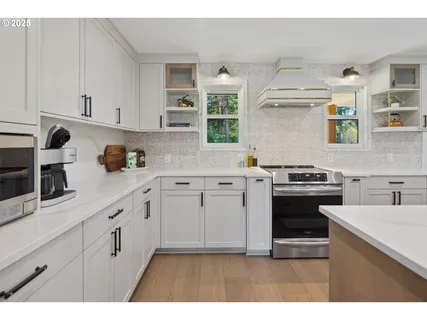a kitchen with cabinets appliances and a window