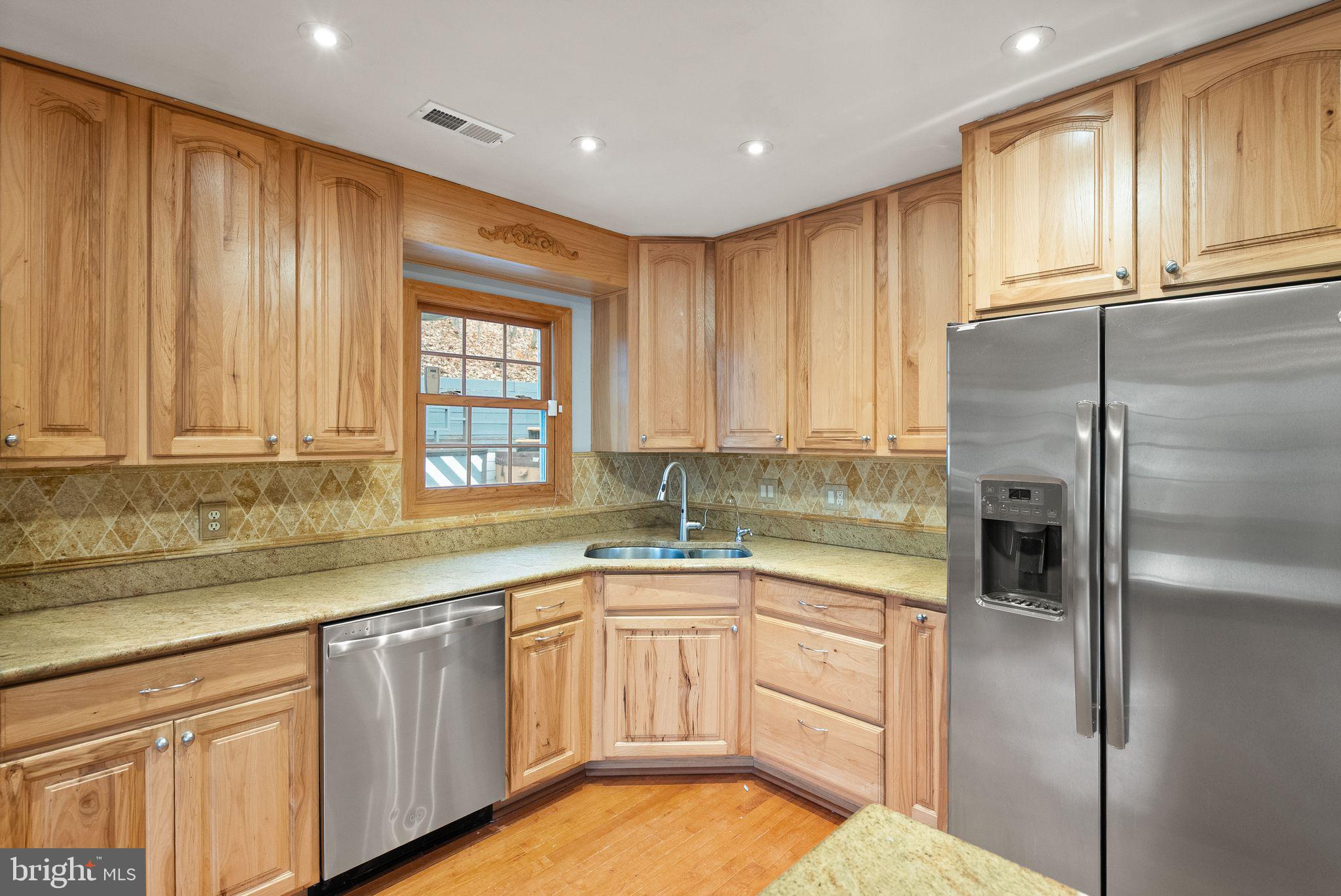 6738 Kelly Road Warrenton, VA 20187 - Photo 11 of 55 a kitchen with a sink window and cabinets