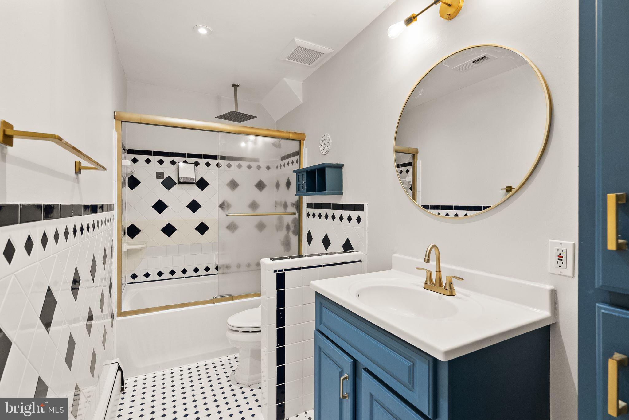 6738 Kelly Road Warrenton, VA 20187 - Photo 20 of 55 a bathroom with a sink a mirror and a shower