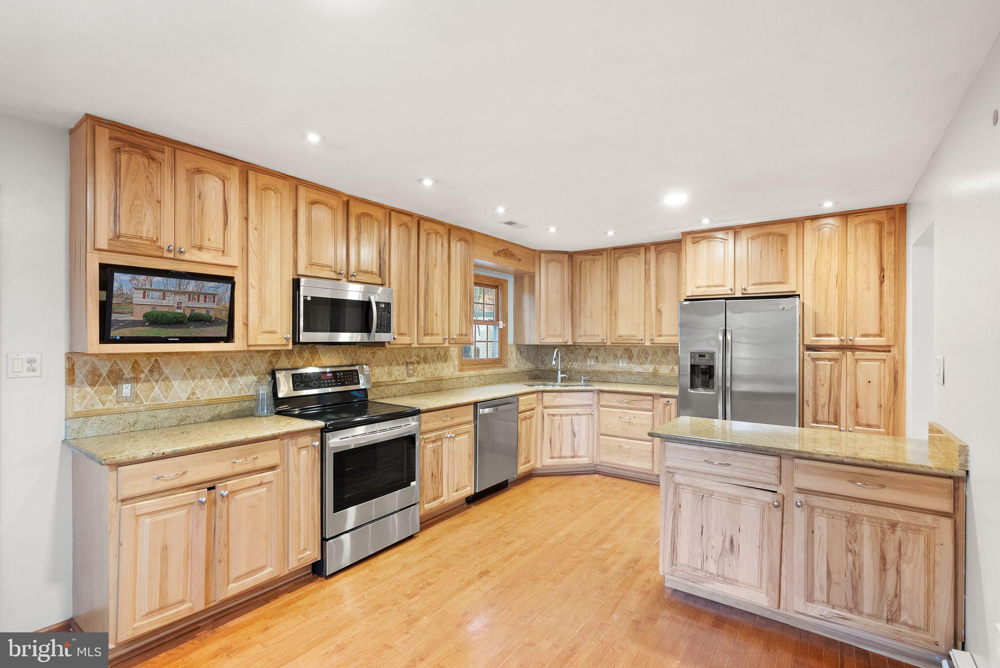 6738 Kelly Road Warrenton, VA 20187 - Photo 9 of 55 a kitchen with granite countertop appliances cabinets and a sink