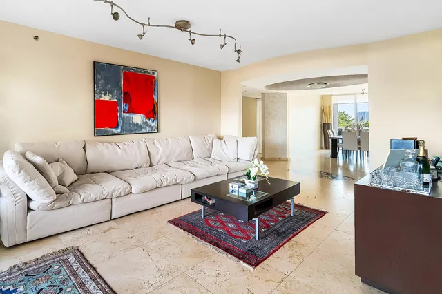 a living room with furniture and a floor to ceiling window