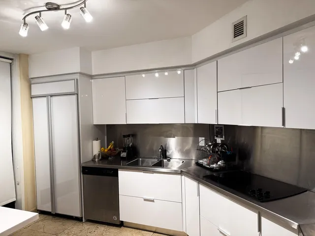 a kitchen with kitchen island a sink and a stove