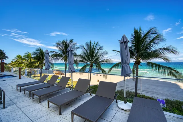a living room with a table and chairs with wooden floor