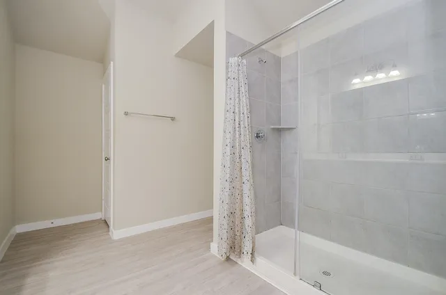 a spacious bathroom with a shower sink and mirror