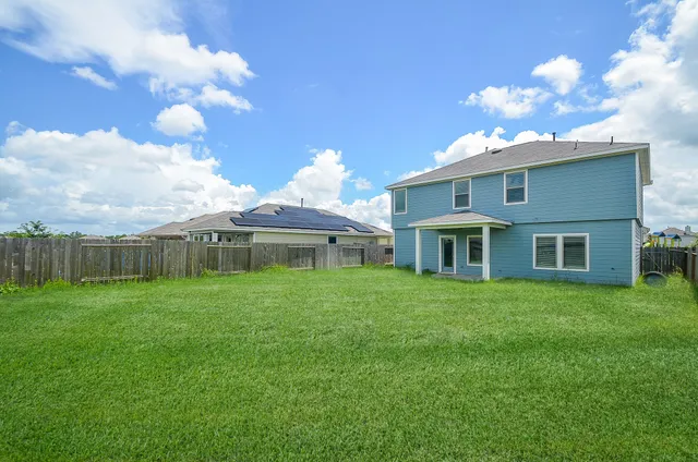 a view of a house with a backyard