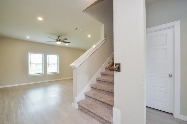 a view of entryway and hall with wooden floor