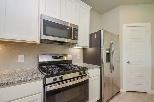a kitchen with a stove microwave and refrigerator