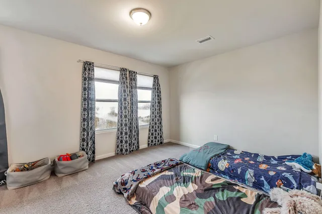 a bedroom with bed and a window