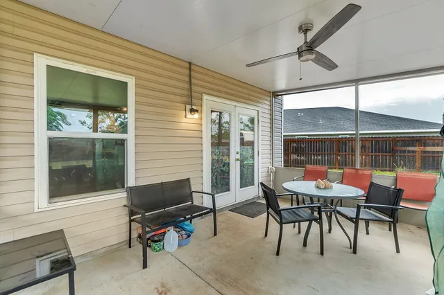 a view of a patio with table and chairs and potted plants