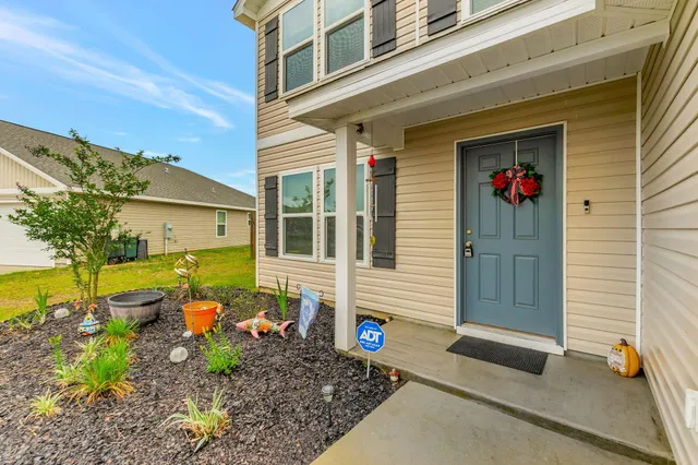 a view of a house with backyard and sitting area
