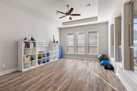 a living room with furniture and a book shelf