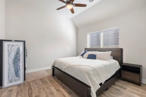 a bedroom with a bed and window