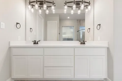 a bathroom with a sink vanity and a mirror