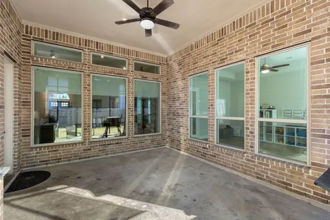 a view of a brick house with a large window