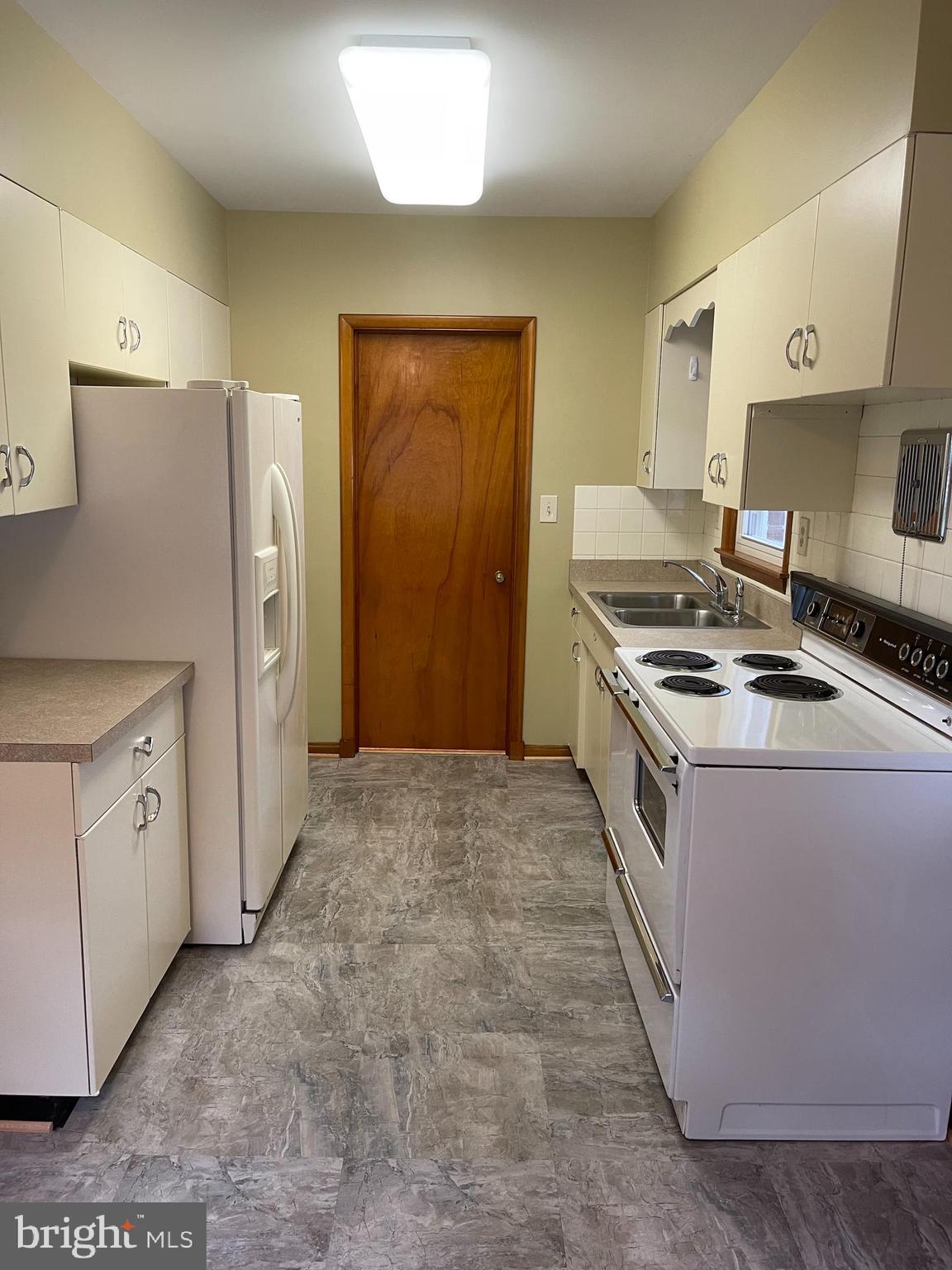 1670 Florence Road Mount Airy, MD 21771 - Photo 13 of 20 a kitchen with white cabinets and white appliances
