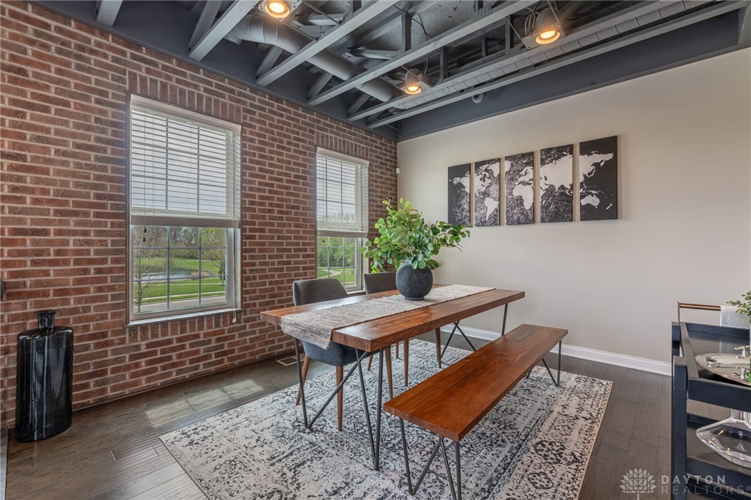 407 Brownstone Row Springboro, OH 45066 - Photo 6 of 54 This versatile dining space features exposed brick and hardwood floors, perfect for any gathering.