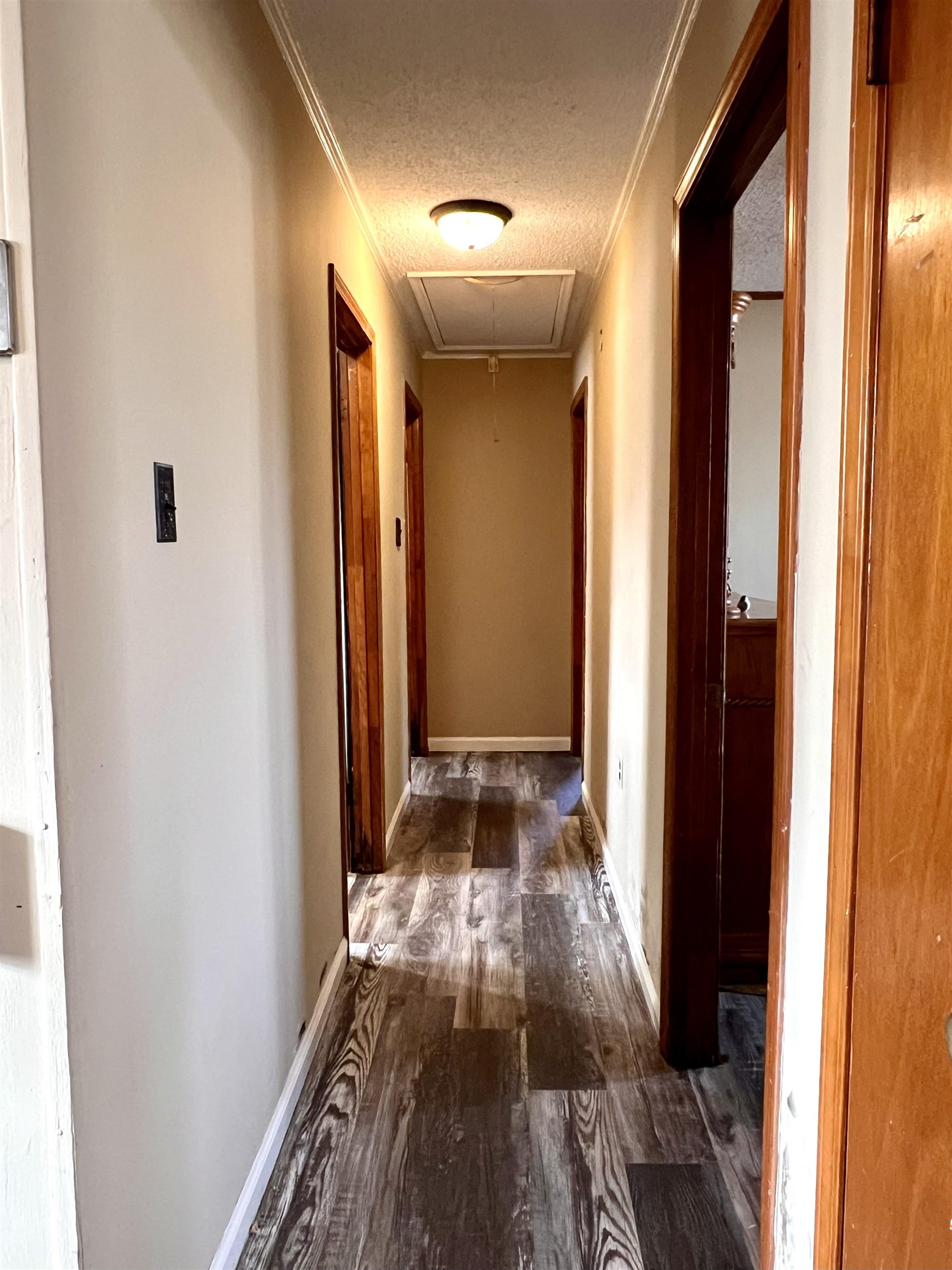 597 Walton Loop Covington, TN 38019 - Photo 13 of 16 a view of a hallway with wooden floor and staircase