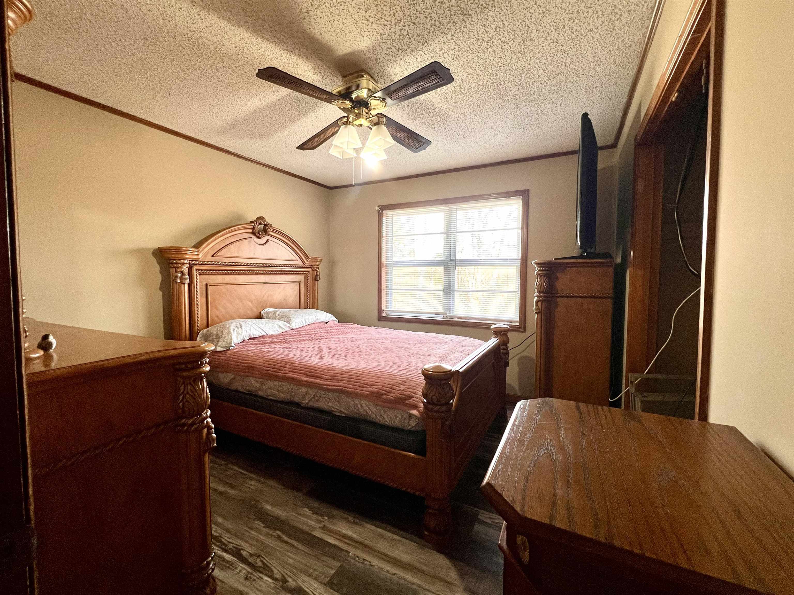 597 Walton Loop Covington, TN 38019 - Photo 14 of 16 a bedroom with a bed and wooden floor