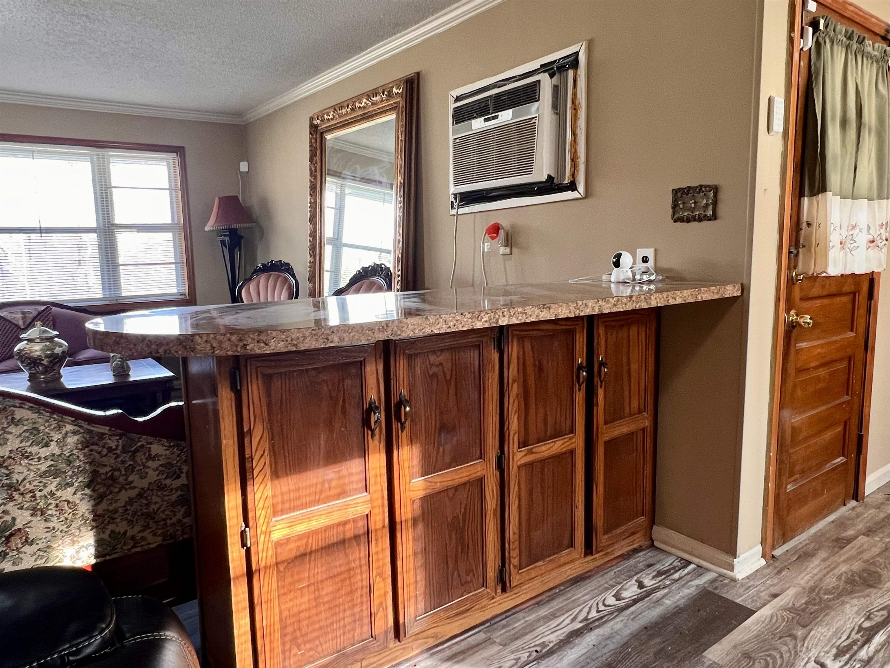 597 Walton Loop Covington, TN 38019 - Photo 7 of 16 a kitchen with granite countertop wooden cabinets a sink and a window