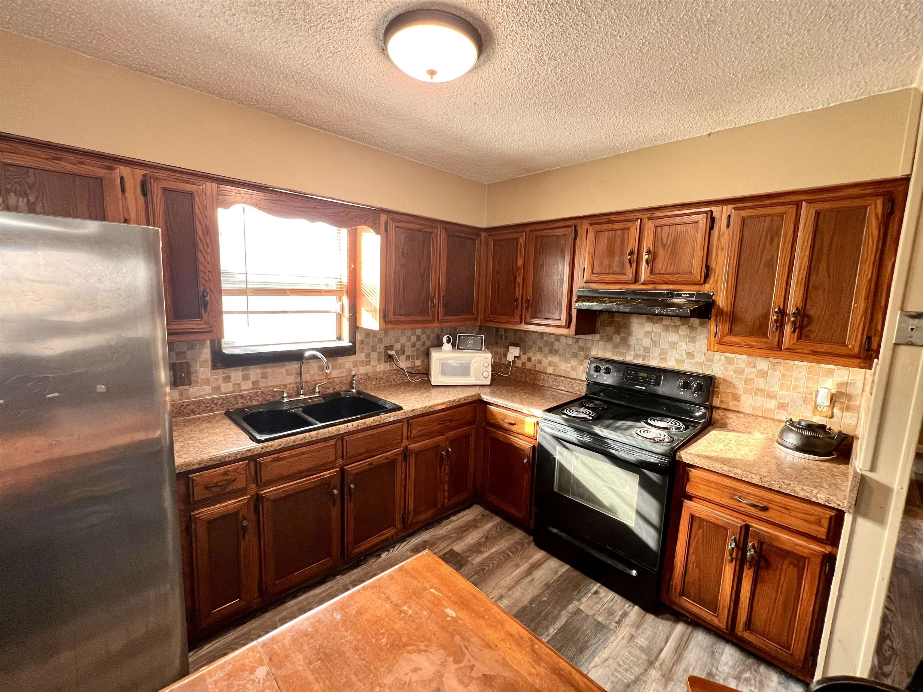 597 Walton Loop Covington, TN 38019 - Photo 9 of 16 a kitchen with stainless steel appliances granite countertop a stove a sink and a refrigerator