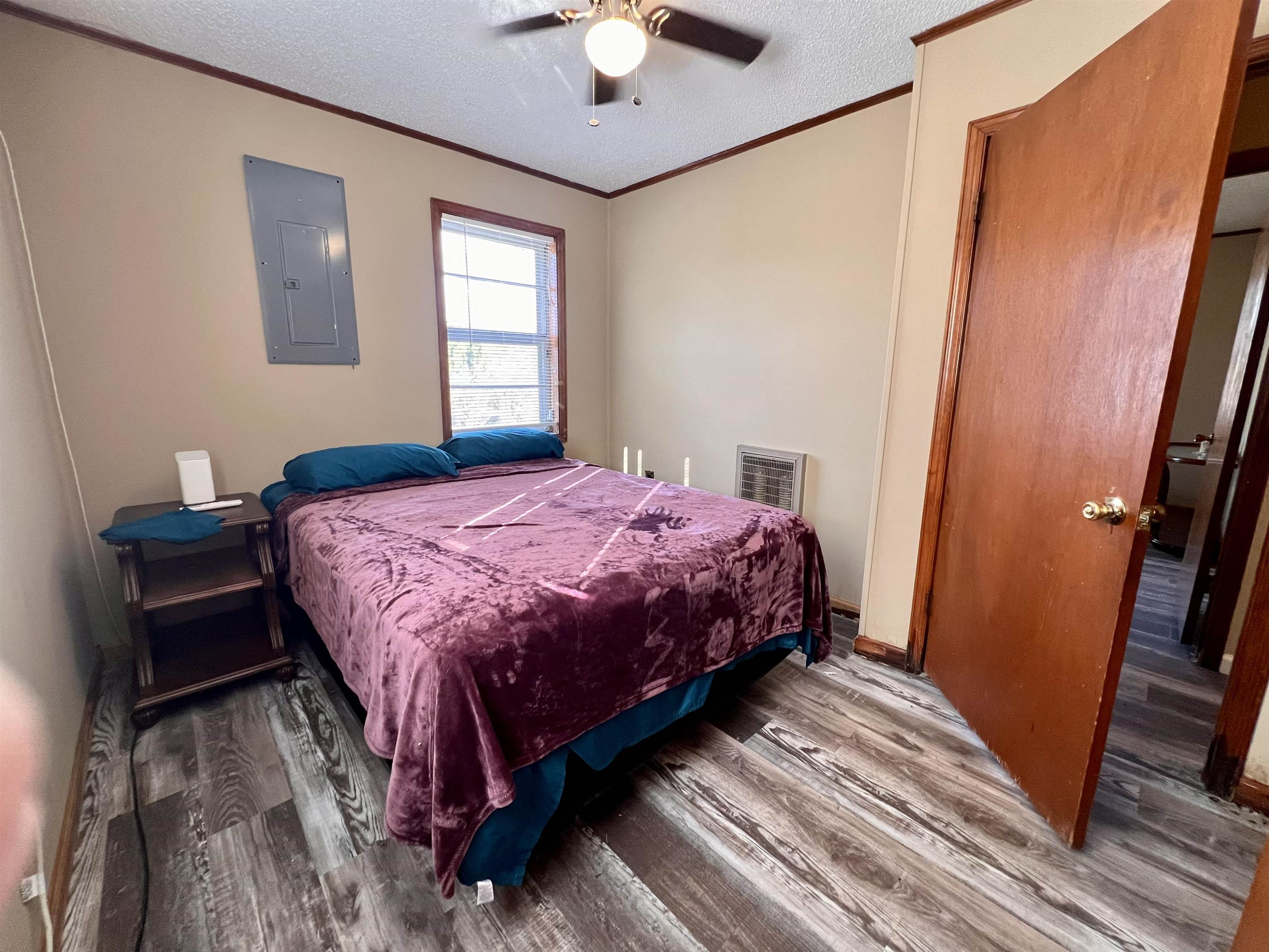 597 Walton Loop Covington, TN 38019 - Photo 10 of 16 a bedroom with a bed and a chandelier